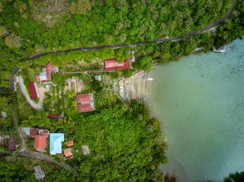 an aerial view of a house next to a body of water at The Hawk's Nest Resort in Sabong