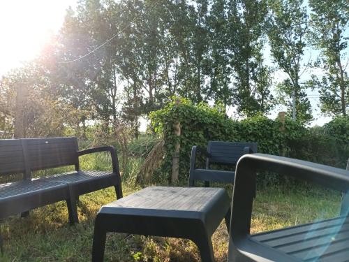 two benches and a table in the grass at gite de la basse pierre près d'Ancenis Loire in Ancenis