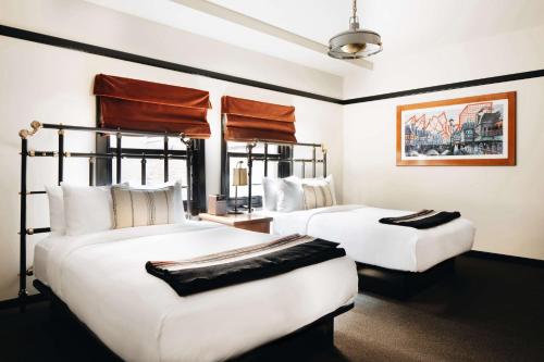 two beds in a hotel room with white walls at Chicago Athletic Association, part of Hyatt in Chicago