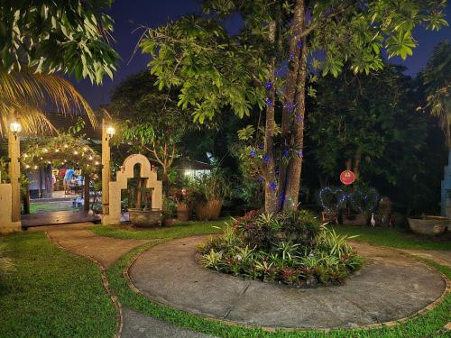 a garden at night with trees and lights at โอบสุขโฮมสเตย์ Oob-Suk in Ban Mae Cho