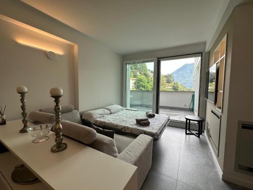 a living room with a couch and a table at Luxury Lake View Apartment - Lake Como - Cernobbio in Cernobbio