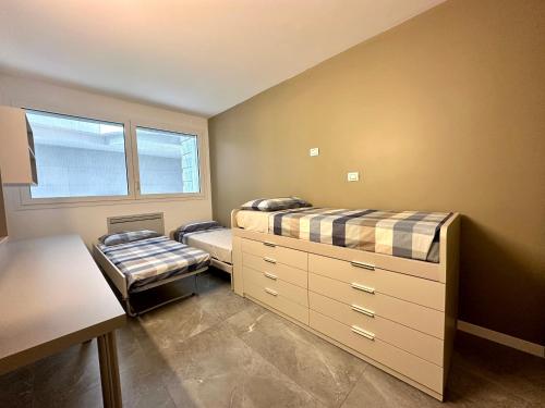 a bedroom with two beds and a desk in it at Luxury Lake View Apartment - Lake Como - Cernobbio in Cernobbio