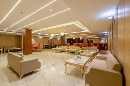 a lobby with couches and tables in a building at Saltstayz Premier - Paschim Vihar in New Delhi