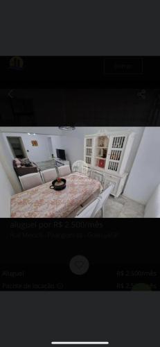 a poster of a bedroom with a bed in a room at Ap da AnaLu no Guarú in Guarujá