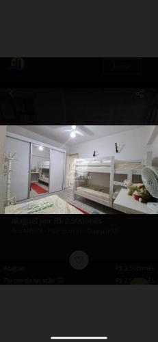 a picture of a bedroom with a bed in a room at Ap da AnaLu no Guarú in Guarujá