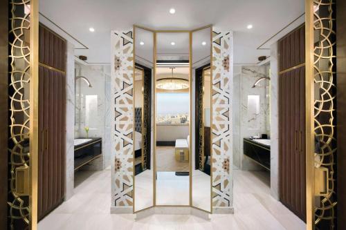 a bathroom with a mirror and a sink at Grand Hyatt Al Khobar Hotel and Residences in Al Khobar