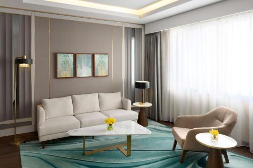 a living room with a white couch and a table at Grand Hyatt Al Khobar Hotel and Residences in Al Khobar