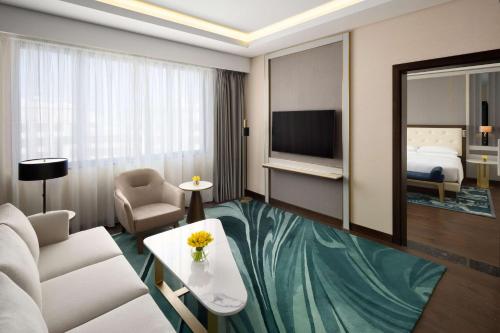 a hotel room with a couch and a bed at Grand Hyatt Al Khobar Hotel and Residences in Al Khobar