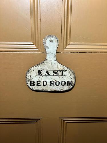 a sign on a door that says red horizons at Uplands Guest House in Ledbury