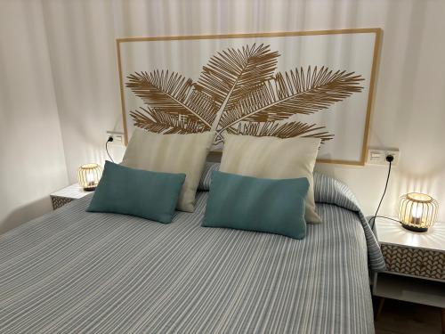 a bedroom with a bed with two pillows and a plant at ValleNiza beach loft in Almayate Alto