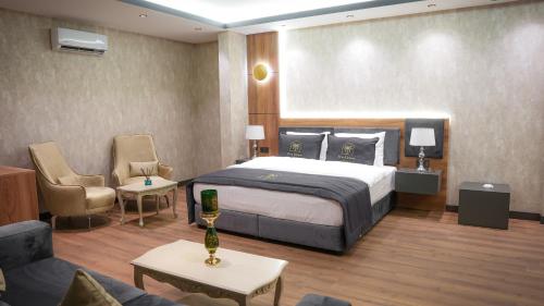 a hotel room with a bed and a couch at SİLVA DELUXE Hotel in Mezitli