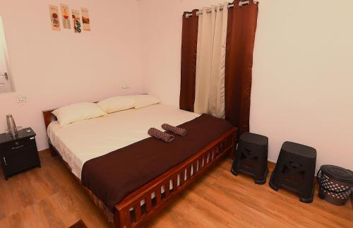 a bedroom with a bed with two speakers at Third Eye Homestay in Cochin