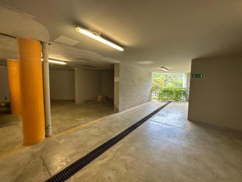 an empty room with orange columns in a building at Luxury Lake View Apartment - Lake Como - Cernobbio in Cernobbio