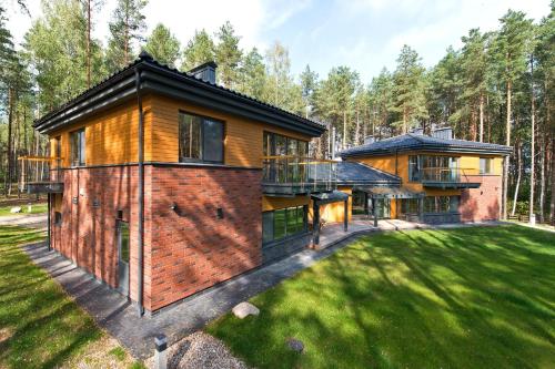 a house in the woods with a large yard at Ami Residence Forest in Didžiasalis