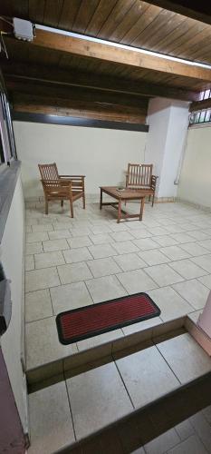 two benches sitting in a room with a rug at B&B Gianni in Capodrise