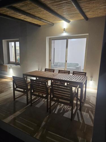 a table and chairs in a room with a large window at Villa Enalia Paphos in Paphos City