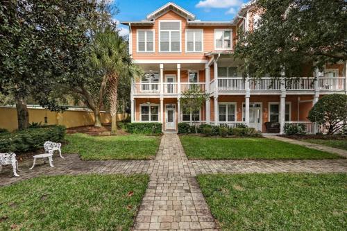 a large peach colored house with a brick driveway at 2142 Cape Sound condo in Fernandina Beach