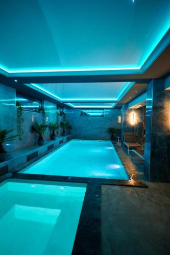 a swimming pool with blue lights in a building at Poiana Bucovat in Gura Humorului