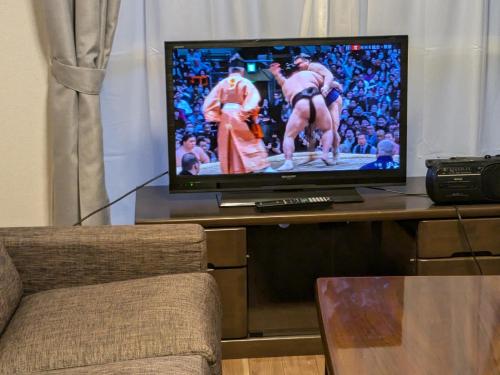 a flat screen tv sitting on top of a table at Colin Home Intimo Amigo in Tokyo
