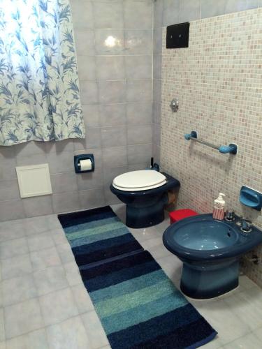 a bathroom with a blue toilet and a sink at Palazzo Scavone in Palermo