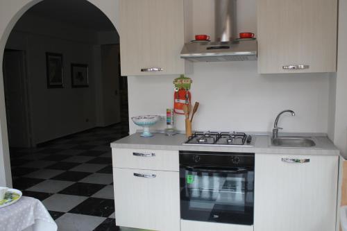 a kitchen with a stove and a counter top at Palazzo Scavone in Palermo