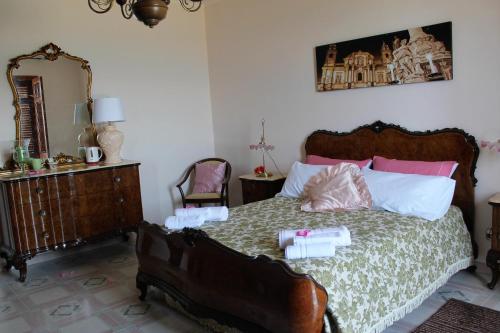 a bedroom with a bed and a mirror at Palazzo Scavone in Palermo
