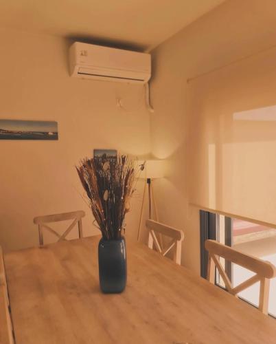 a vase sitting on top of a wooden table at Maria’s family house’s in Elafonisos