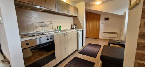 a kitchen with a sink and a stove at Aspen golf studio B402 in Razlog