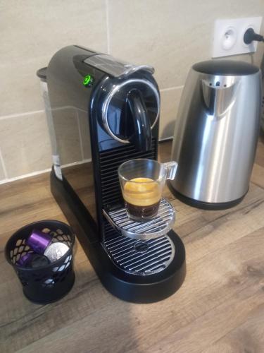 a coffee maker sitting on a counter with a cup of coffee at Appartement neuf, parking privé, 2 chambres in Bischheim