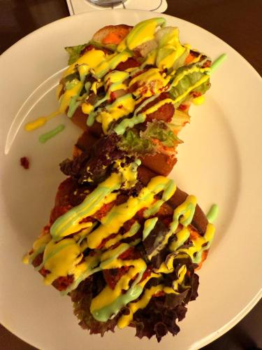 a white plate with two pieces of food on it at Hotel Tulsi Grand inn in Vrindāvan