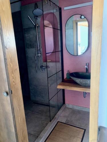 a bathroom with a sink and a shower with a mirror at Ersi's View in Porto Rafti