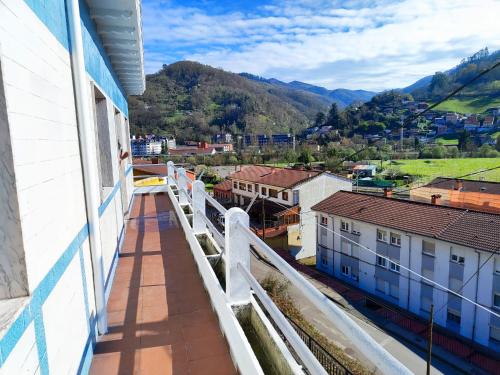a balcony with a view of a city and mountains at Asturias Montaña y Playa in La Vega