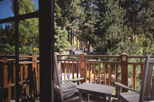 a porch with two chairs and a table on a deck at Hyatt Regency Lake Tahoe Resort, Spa & Casino in Incline Village