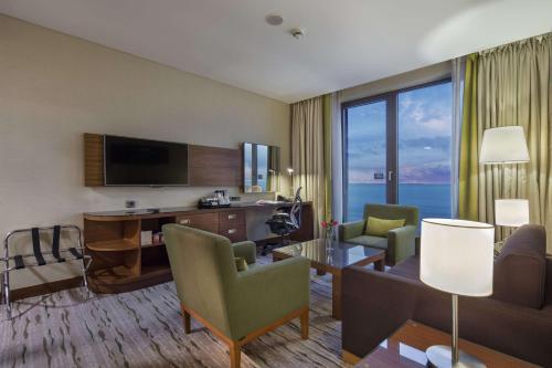 a large hotel room with a living room at DoubleTree by Hilton Trabzon in Trabzon