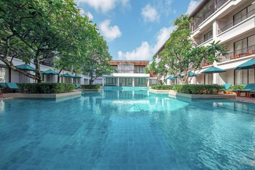 a swimming pool in the middle of a building at DoubleTree by Hilton Phuket Banthai Resort in Patong Beach
