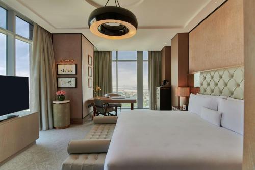 a bedroom with a large bed and a desk at Waldorf Astoria Dubai International Financial Centre in Dubai