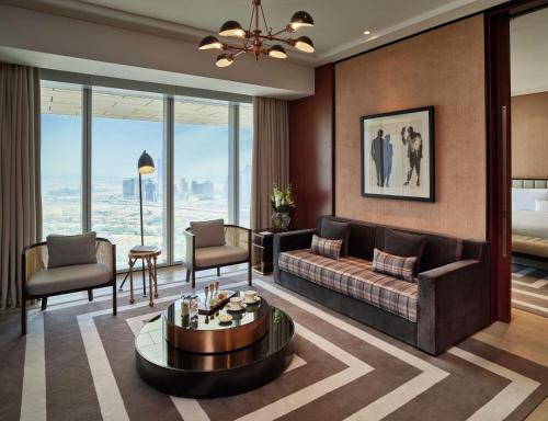 a living room with a couch and a table at Waldorf Astoria Dubai International Financial Centre in Dubai