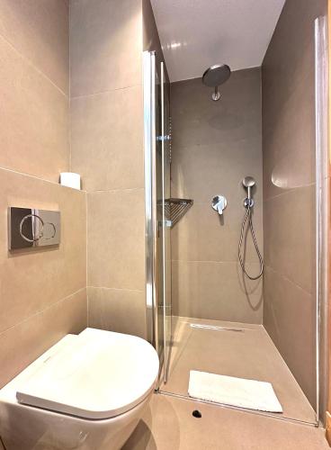a bathroom with a toilet and a shower at Kumluk Hotel in Datca