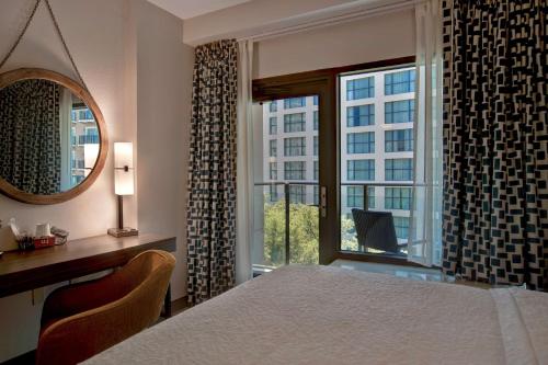 a bedroom with a bed and a large window at Hampton Inn & Suites San Antonio Riverwalk in San Antonio