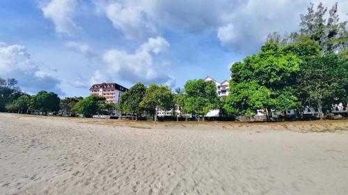 a view of a beach with trees and buildings at 5-10 pax, GFloor cozy staycation chill place in Port Dickson