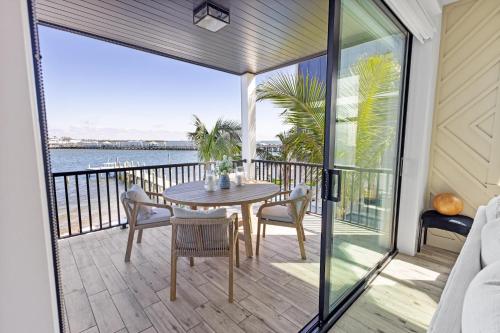 a patio with a table and chairs on a balcony at Big Nauti in Bradenton Beach