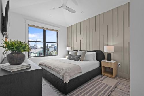 a bedroom with a large bed and a window at Big Nauti in Bradenton Beach