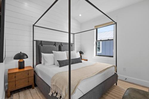 a bedroom with a large bed with a canopy at Big Nauti in Bradenton Beach