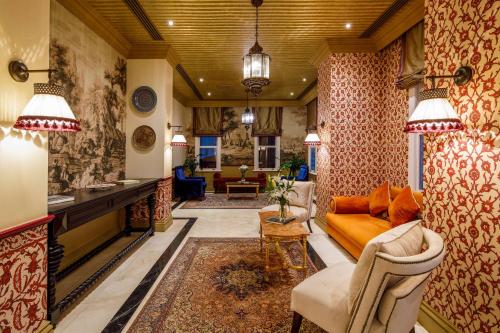 a living room with a couch and a table at Hagia Sofia Mansions Istanbul, Curio Collection by Hilton in Istanbul