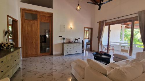 a living room with a couch and a table at Sunny Villa in Beruwala