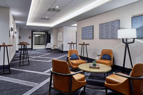 a waiting room with chairs and a table at Cumberland House Knoxville, Tapestry Collection by Hilton in Knoxville