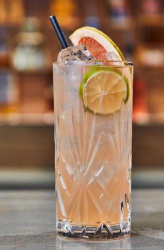 a glass of lemonade with a slice of lime at Cumberland House Knoxville, Tapestry Collection by Hilton in Knoxville