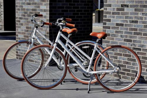 a bike parked on a sidewalk next to a brick wall at Cumberland House Knoxville, Tapestry Collection by Hilton in Knoxville
