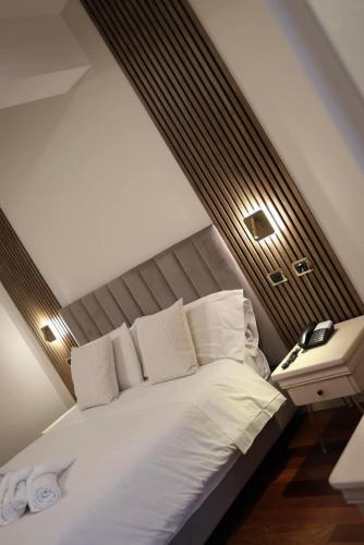a bedroom with a large white bed and a nightstand at CASA REALE in Frigento