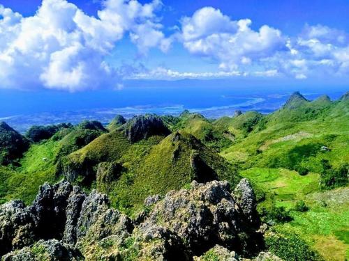 a view of a mountain range with green hills at Moalboal Tropics in Moalboal